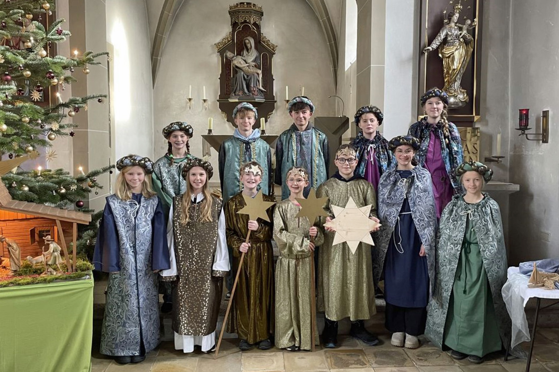 Eine Gruppe von Kindern hat die neuen Kleider an und schaut in die Kamera.